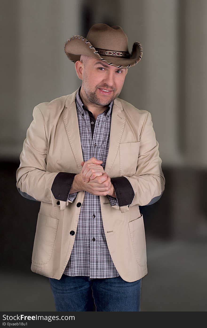 The man`s portrait in a cowboy`s hat.