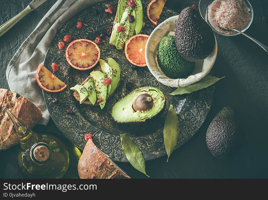 Toast with avocado and oil. Bread with avocado. Concept of healthy food. Dark background