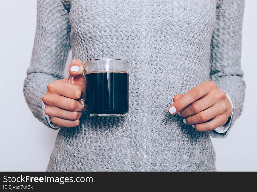 Transparent coffee cup in female hands