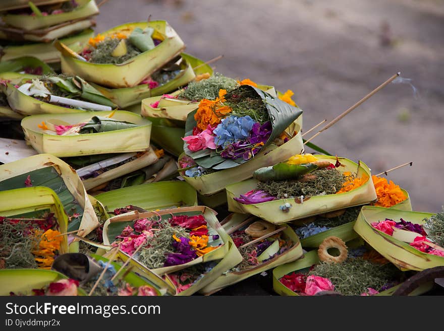 Colorful exotic flowers and incenses stacked. Hindu God& x27;s offerings in Balinese tradition. Colorful exotic flowers and incenses stacked. Hindu God& x27;s offerings in Balinese tradition