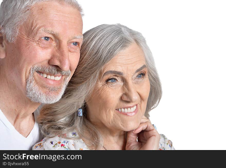 Portrait of hugging senior couple isolated on white background