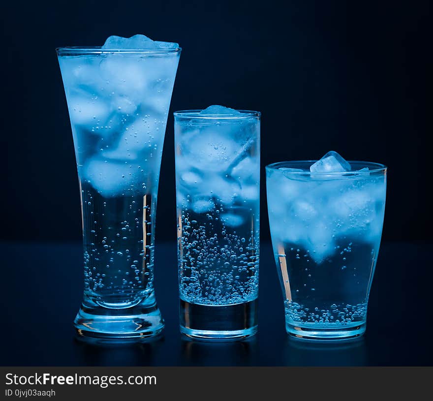 Beautiful nature drink background. Fresh mineral cold water in glasses and ice. Healthy lifestyle. Detox diet. Food ecology drinking. Soda blue water. Aqua life. Close up. Beautiful nature drink background. Fresh mineral cold water in glasses and ice. Healthy lifestyle. Detox diet. Food ecology drinking. Soda blue water. Aqua life. Close up.