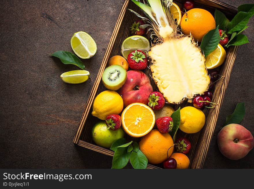 Fruit And Berries Over Dark Stone Table.