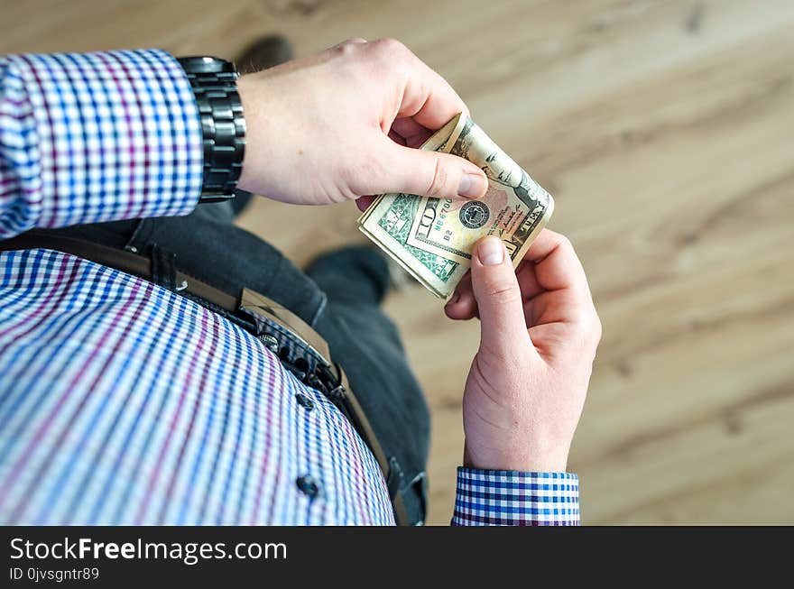 Person Holding 100 Us Dollar Banknote