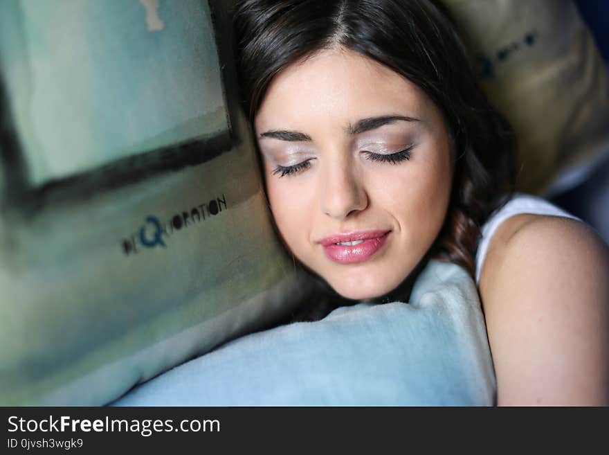 Woman Sleeping While Holding Pillow