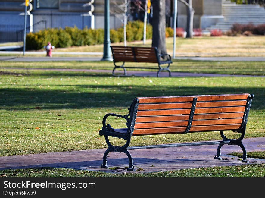 Black Metal Framed Brown Wooden Bench on Park