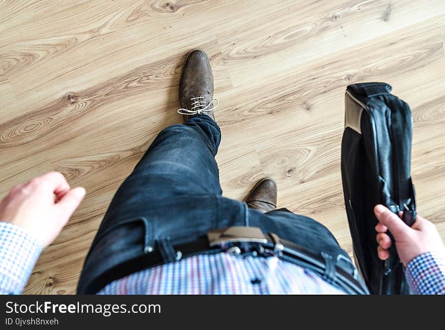 Man Walking Holding Leather Bag