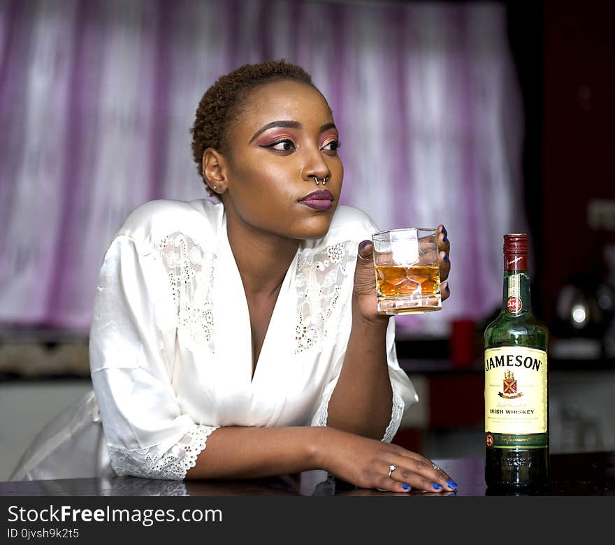 Woman Wears White Lace Bathrobe Holds Shot Glass