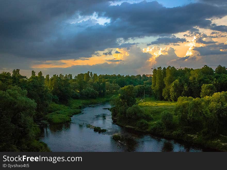 Photo of River Between Green Grass Fields