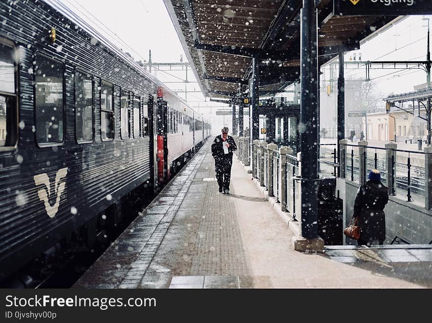 Man Walks Beside Train