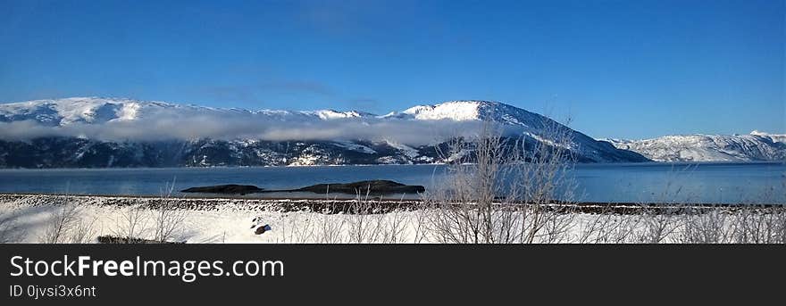 Mountain Coated With Snow Under Blue Sky