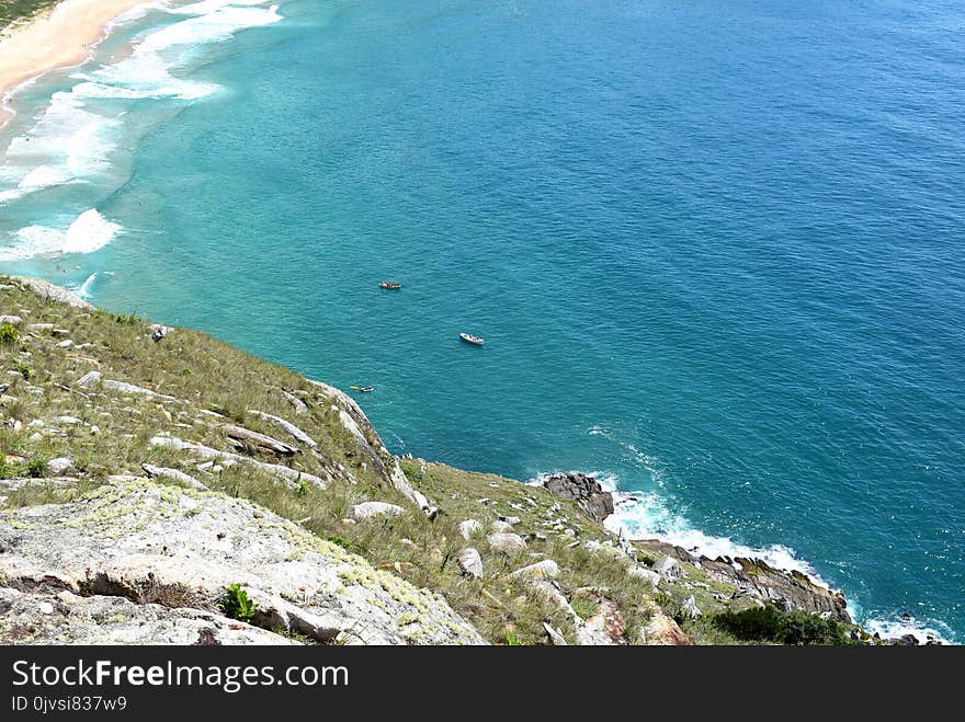 Aerial Photography of White Boat on Body of Water Near Seashore