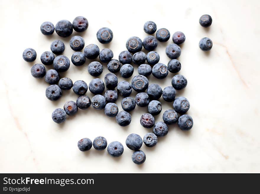 Photo of Black Berries on White Surface