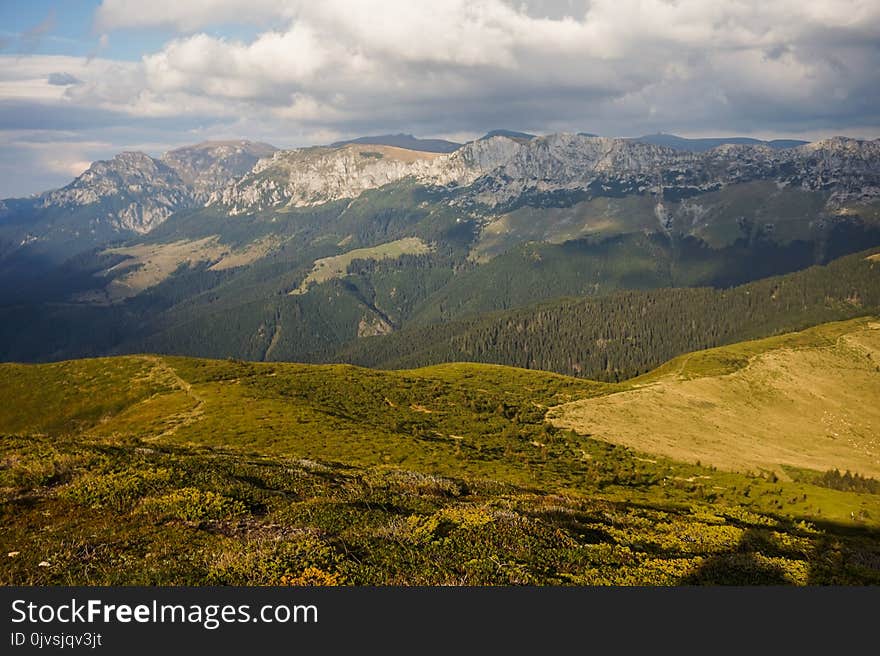 Green Mountain Range Under Cloudy Skies