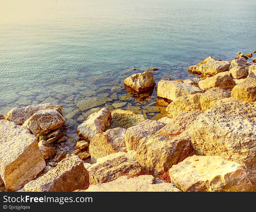 Photo of Boulders Near Body of Water