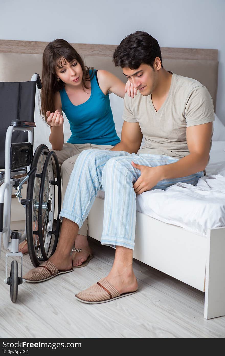 The Desperate Man On Wheelchair With His Sad Wife