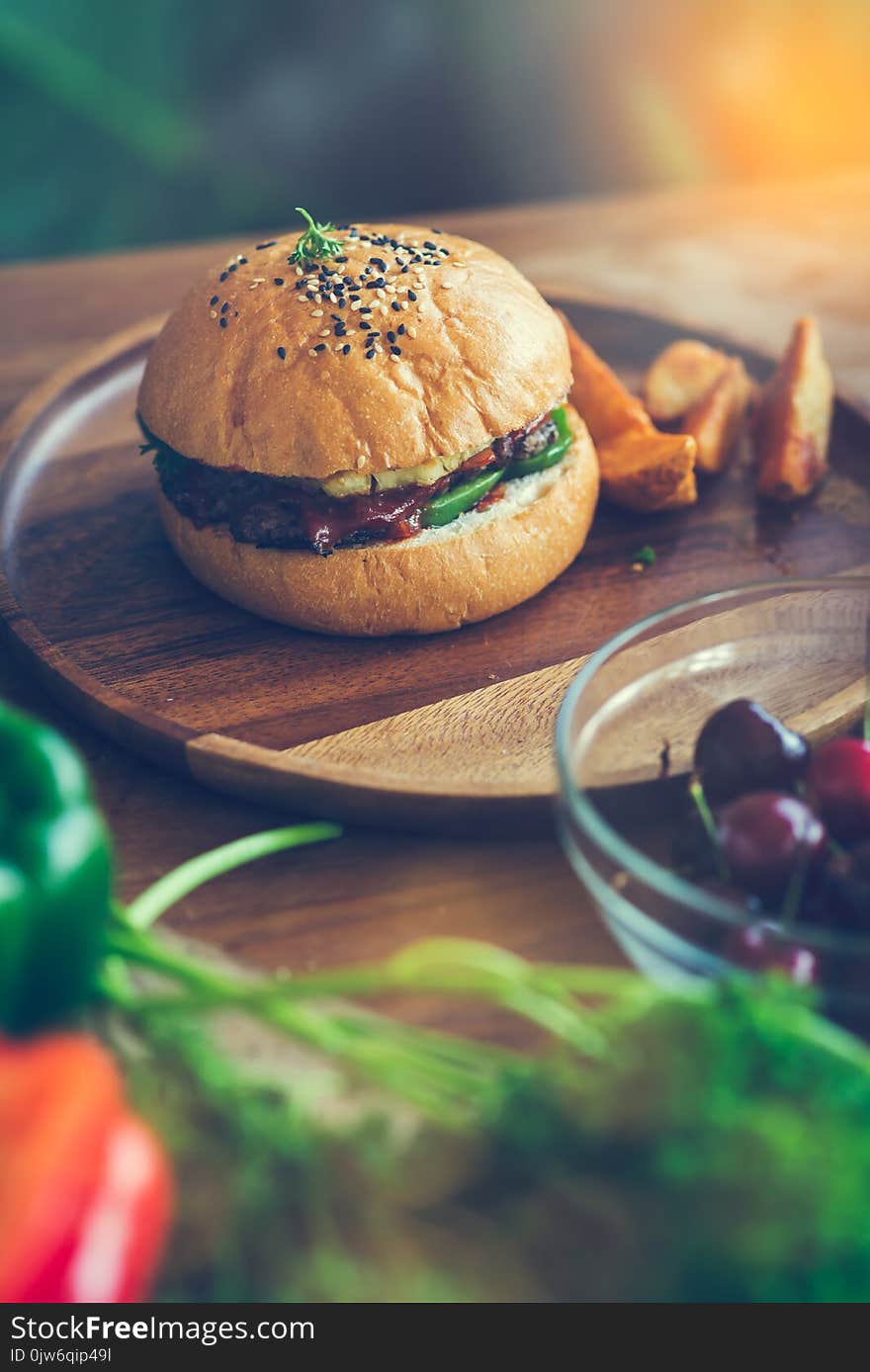 Meat burger on wooden plate with vegetable