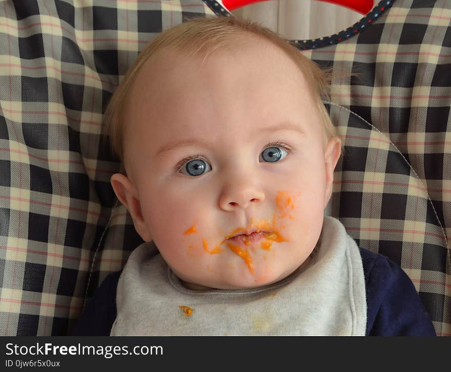 Baby in a high chair at dinner time