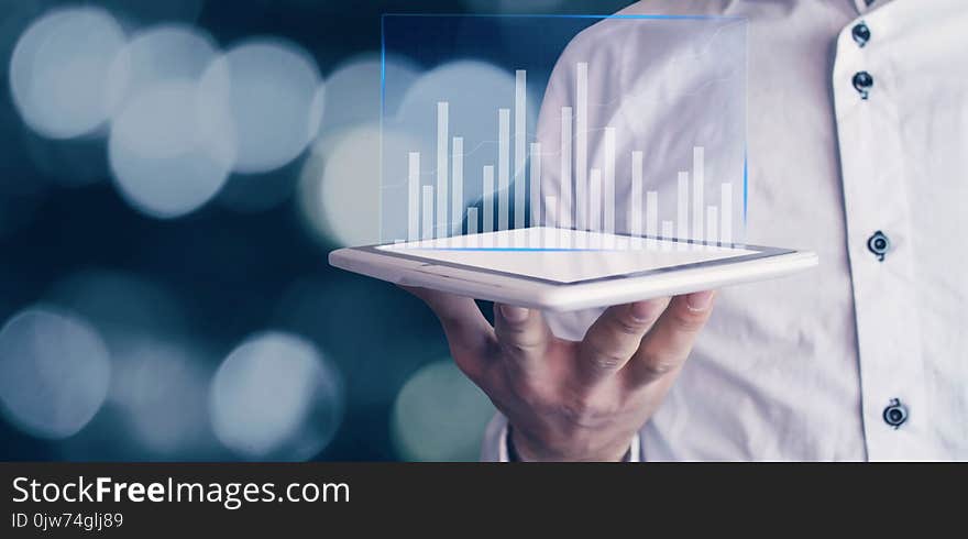 Businessman holding graph in the tablet. Finance concept. Businessman holding graph in the tablet. Finance concept