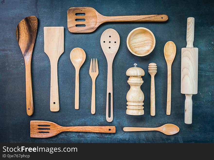 Kitchen utensils with copy space on black stone background