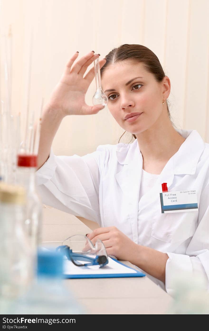 Woman Lab Assistant Holding A Empty Test Tube And Watch Closely On It