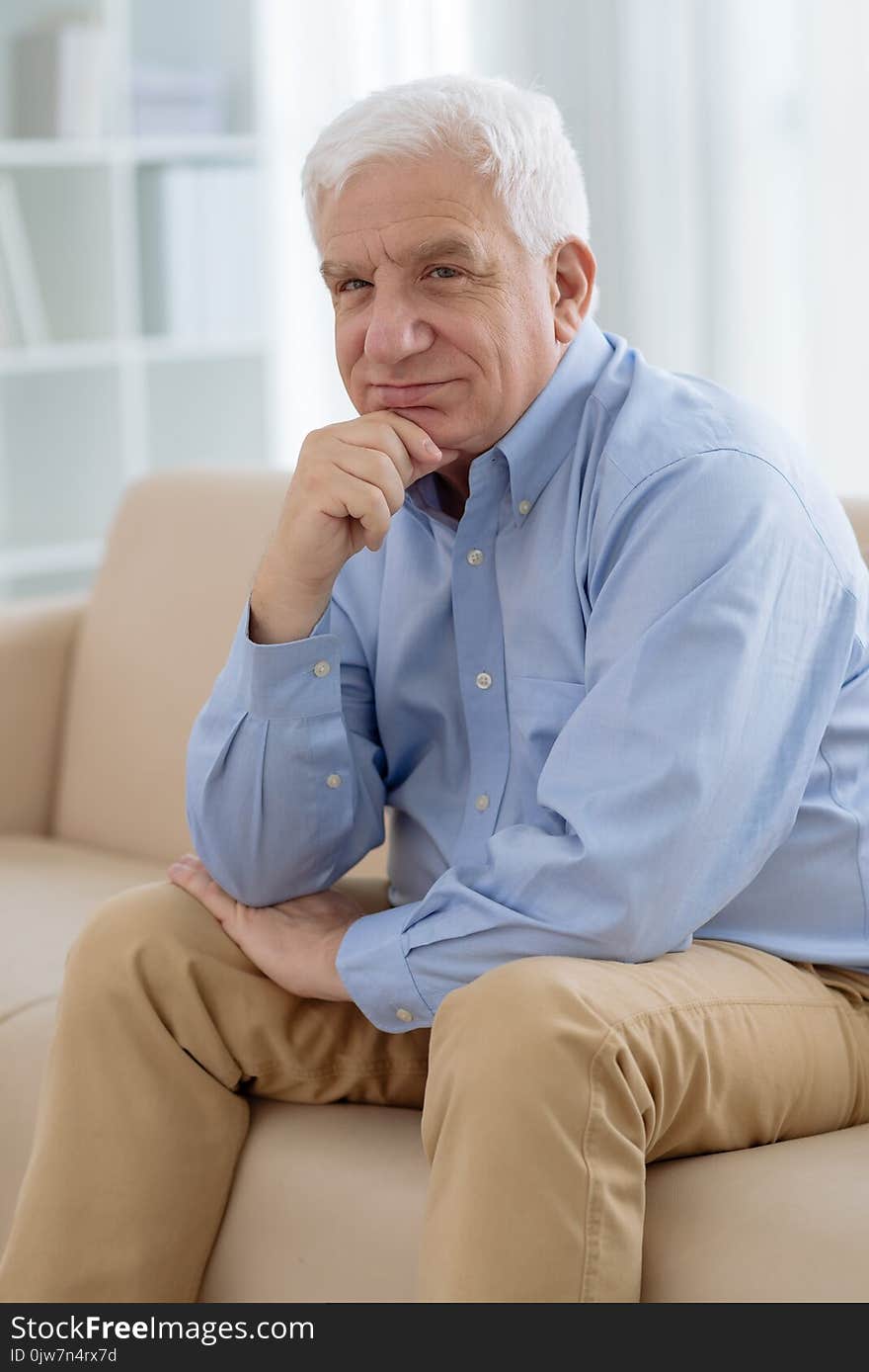 Portrait of pensive senior man resting on sofa. Portrait of pensive senior man resting on sofa