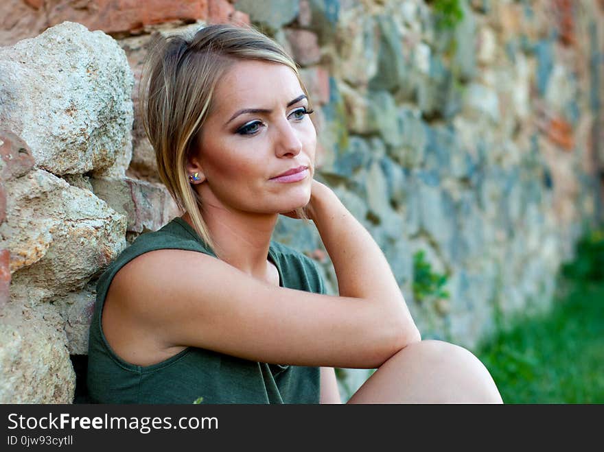 Outdoor portrait of a sad, moody or depressed, beautiful blonde woman. Outdoor portrait of a sad, moody or depressed, beautiful blonde woman