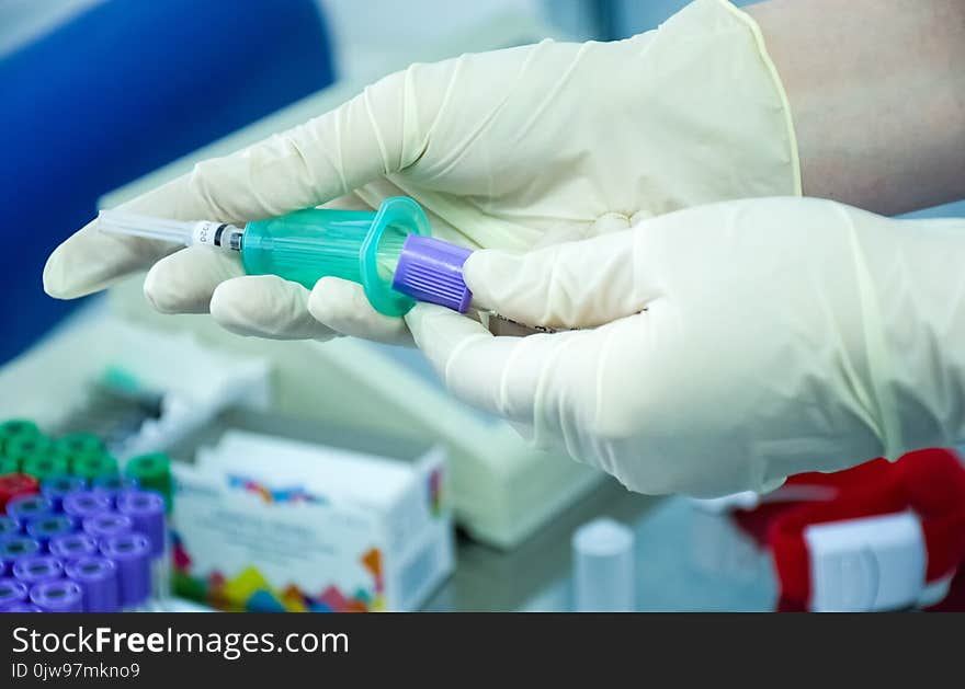 Preparing to take blood for analysis or scientific research by doctor or medical nurse with vacuum container for biological fluids. Medic in gloves holding lab container specimen for blood collection