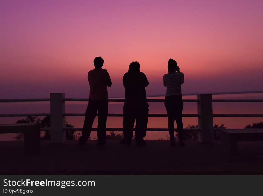 Silhouette photographer shooting sunset.