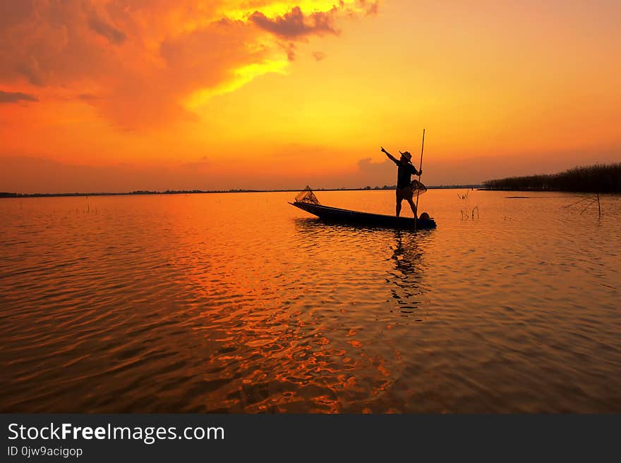 Silhouette fisherman with sunset,Take photo fisherman young woman with sunset