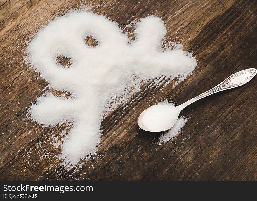 Skull made of granulated sugar. A conceptual photo illustrating the harm from consuming white refined sugar and products containing it