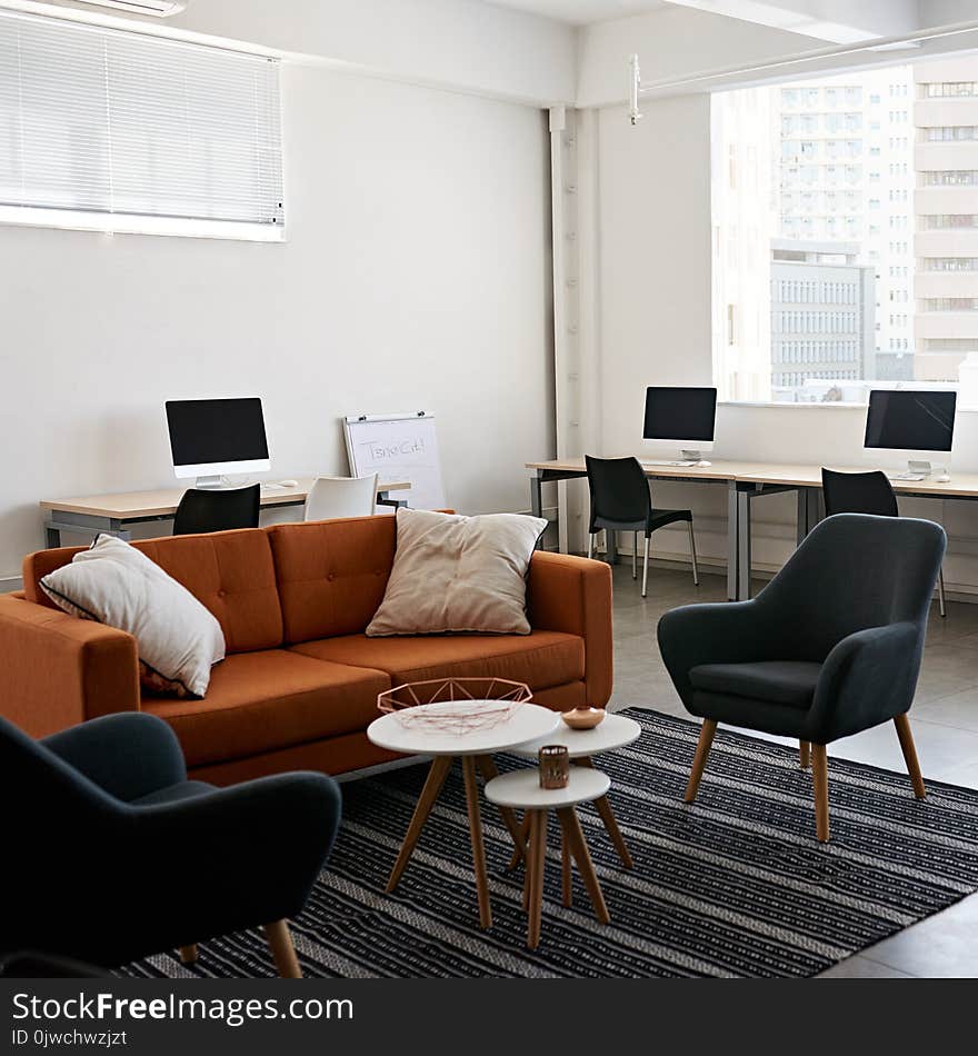 Square image of modern office space with tables and chairs, computers and office supplies with no employees. Square image of modern office space with tables and chairs, computers and office supplies with no employees