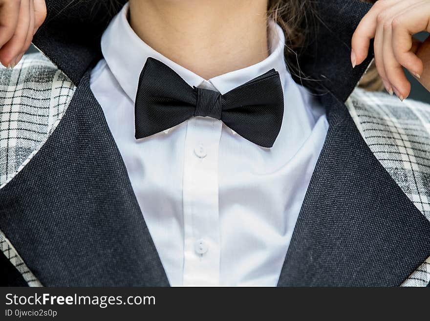 Close Up Of Young Woman Holding Her Collar In White Shirt And Bl