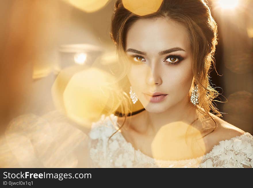 Portrait of beautiful and fashionable brown-haired model girl, in a lace dress.