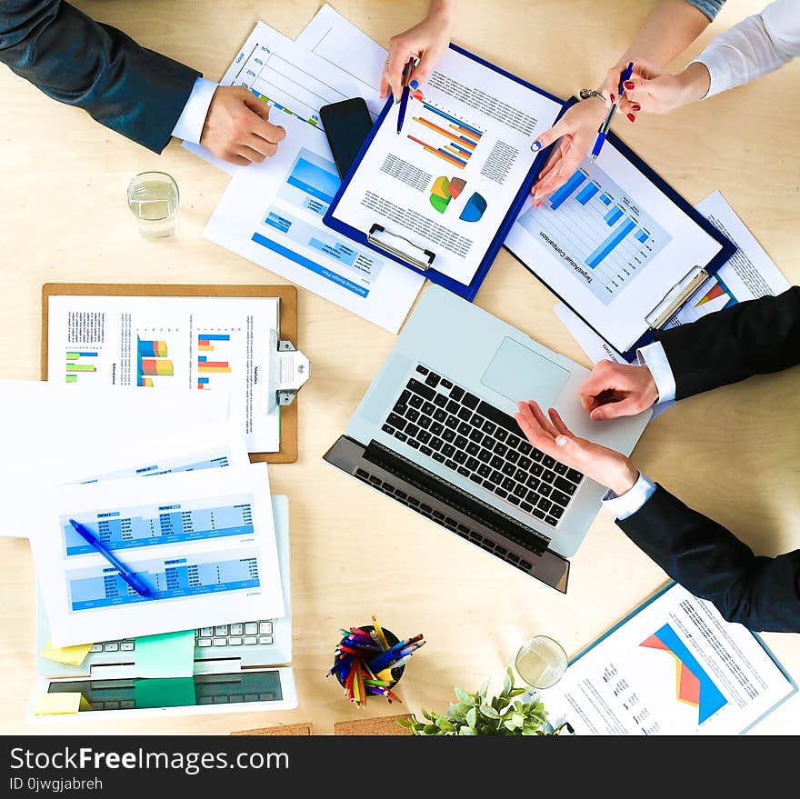 Business people sitting and discussing at business meeting, in office