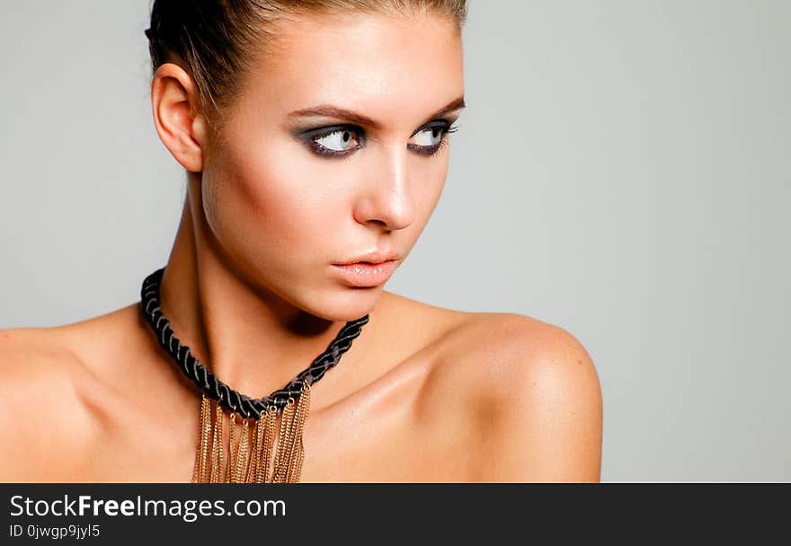 Portrait Of A Beautiful Woman With Necklace, On White Background