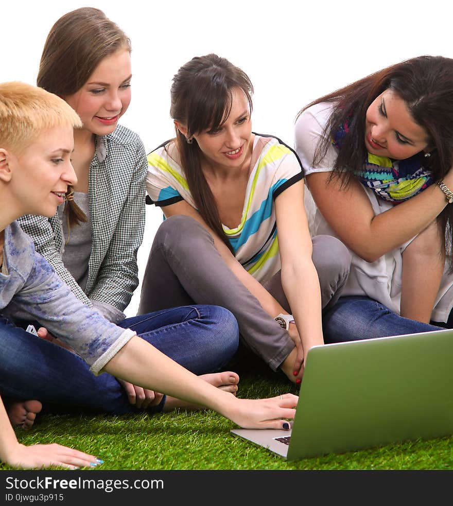 Group of young student usitting on green grass .