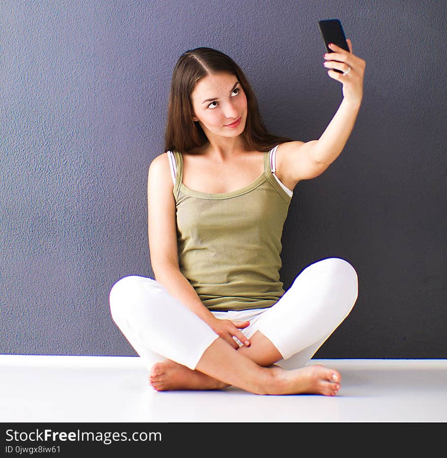 Attractive caucasian girl sitting on floor