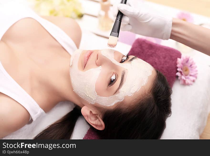 Woman With Mask On Her Face Having Head Massage.