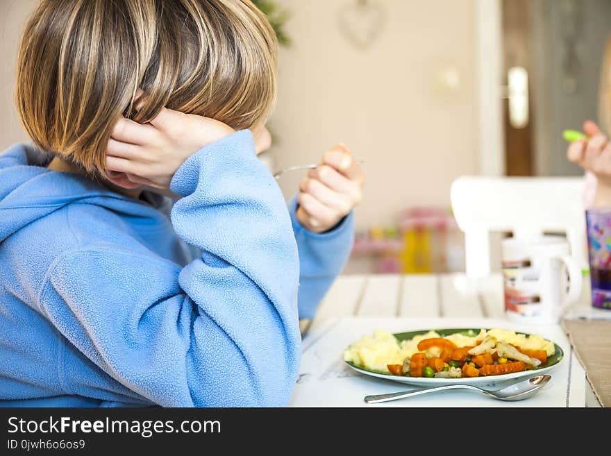 Tired boy does not like to eat his lunch.