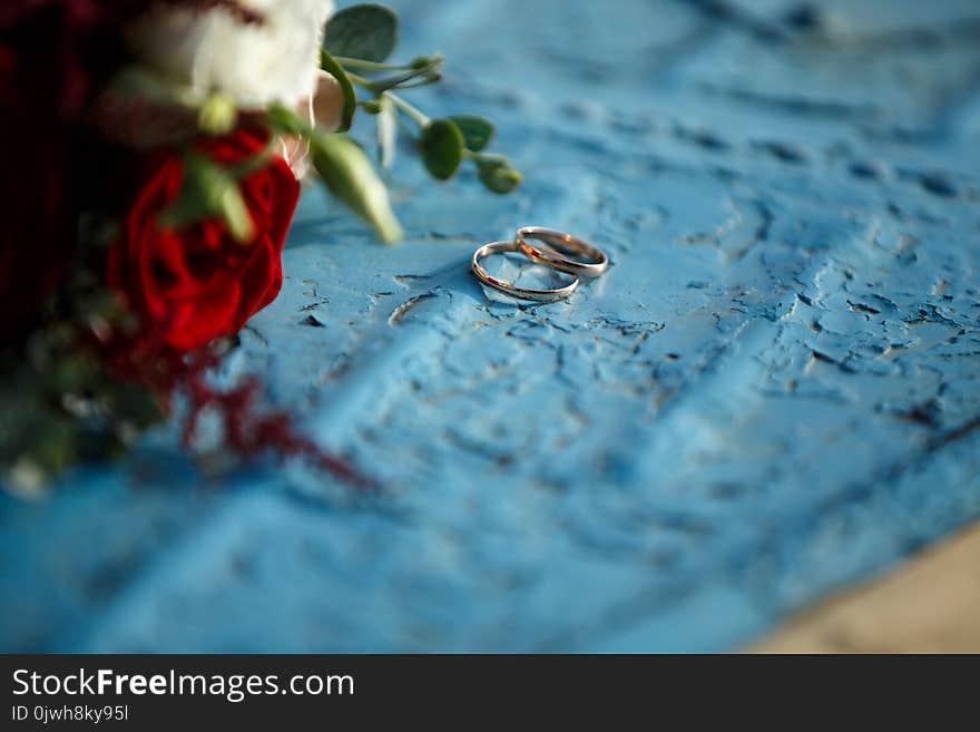 Wedding bouquet with red roses lies on a blue background. Wedding bouquet with red roses lies on a blue background