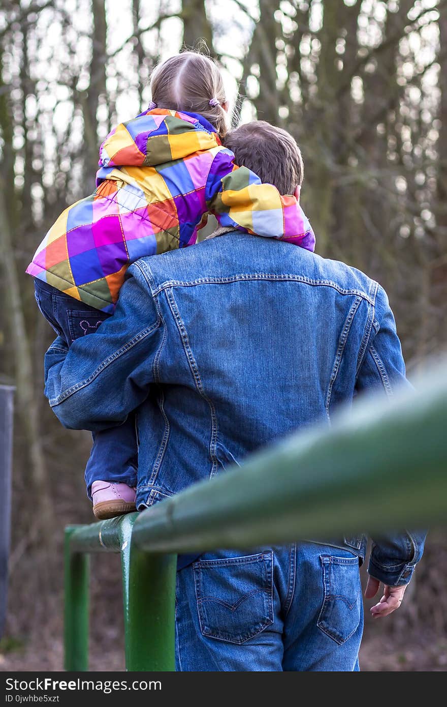 Father being an everyday superhero helping daughter to climb