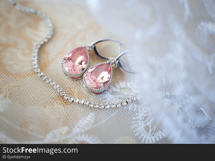 Pink crystal earrings for bride with white necklace