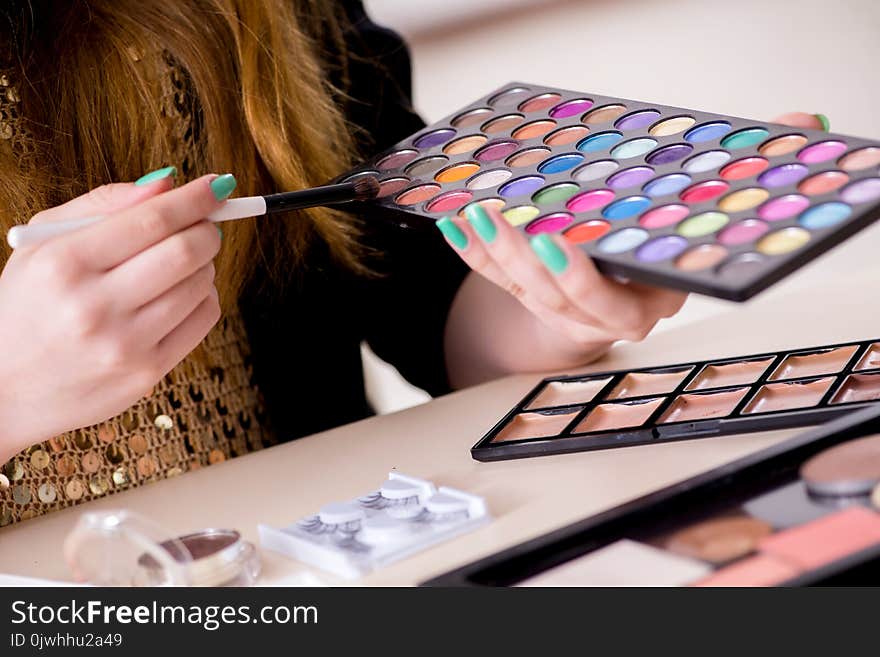 The Young Woman Applying Make-up Preparing For Party