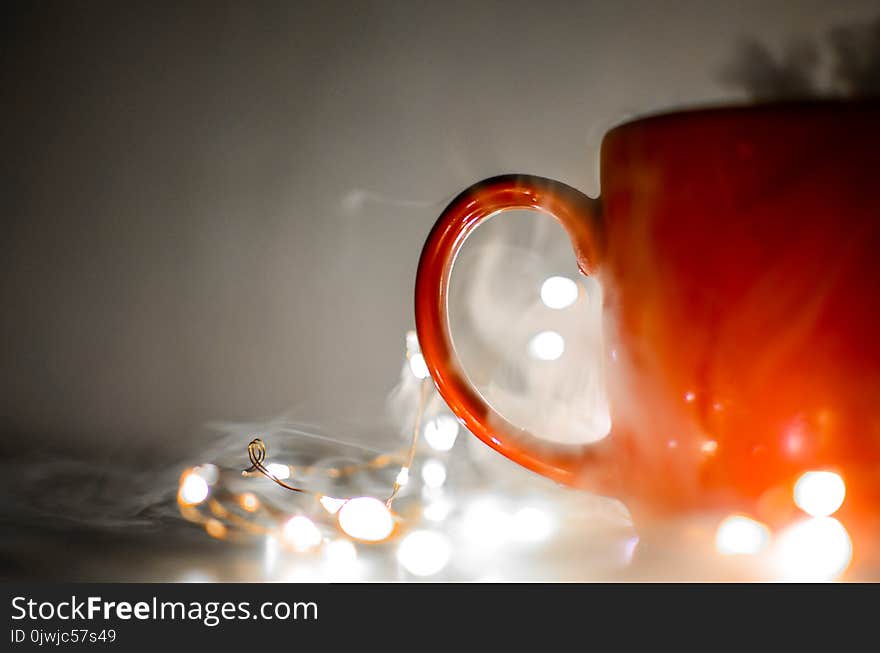 Red Mug Beside String Lights