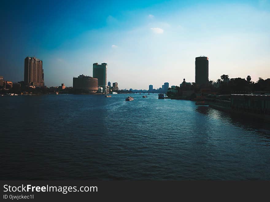 Boats on Water With High Rise Building Background