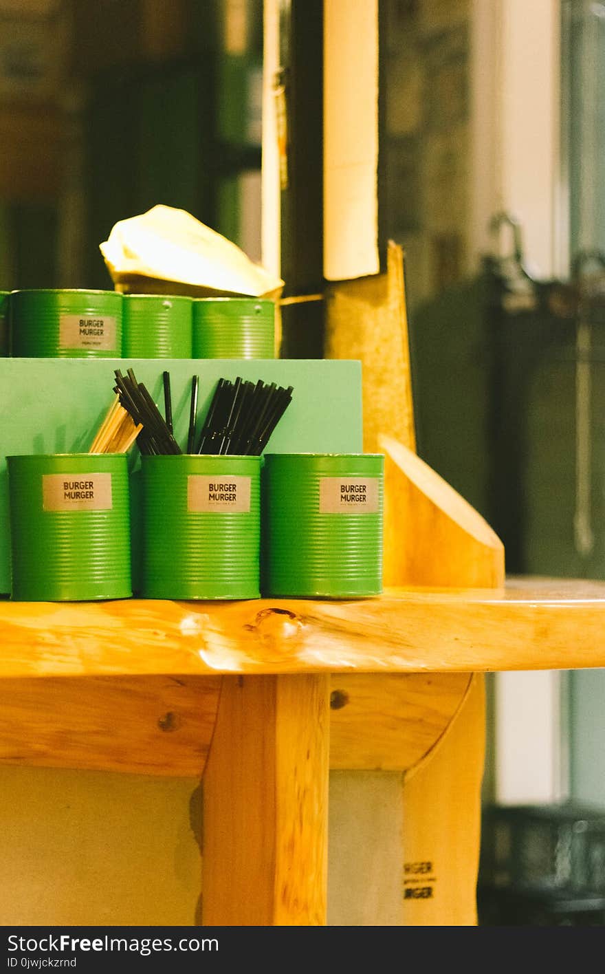 Six Green Tin Can Containers on Table