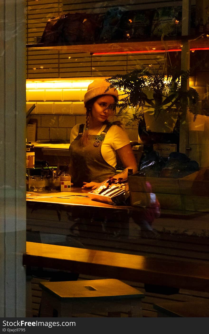 Woman Wearing Brown Apron Standing Near Table