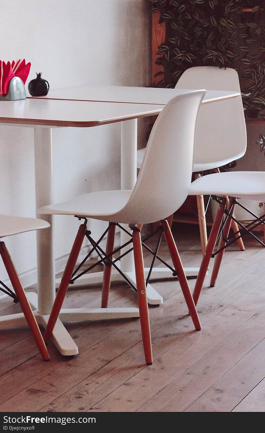 Two White Loo Tables With Four Chairs