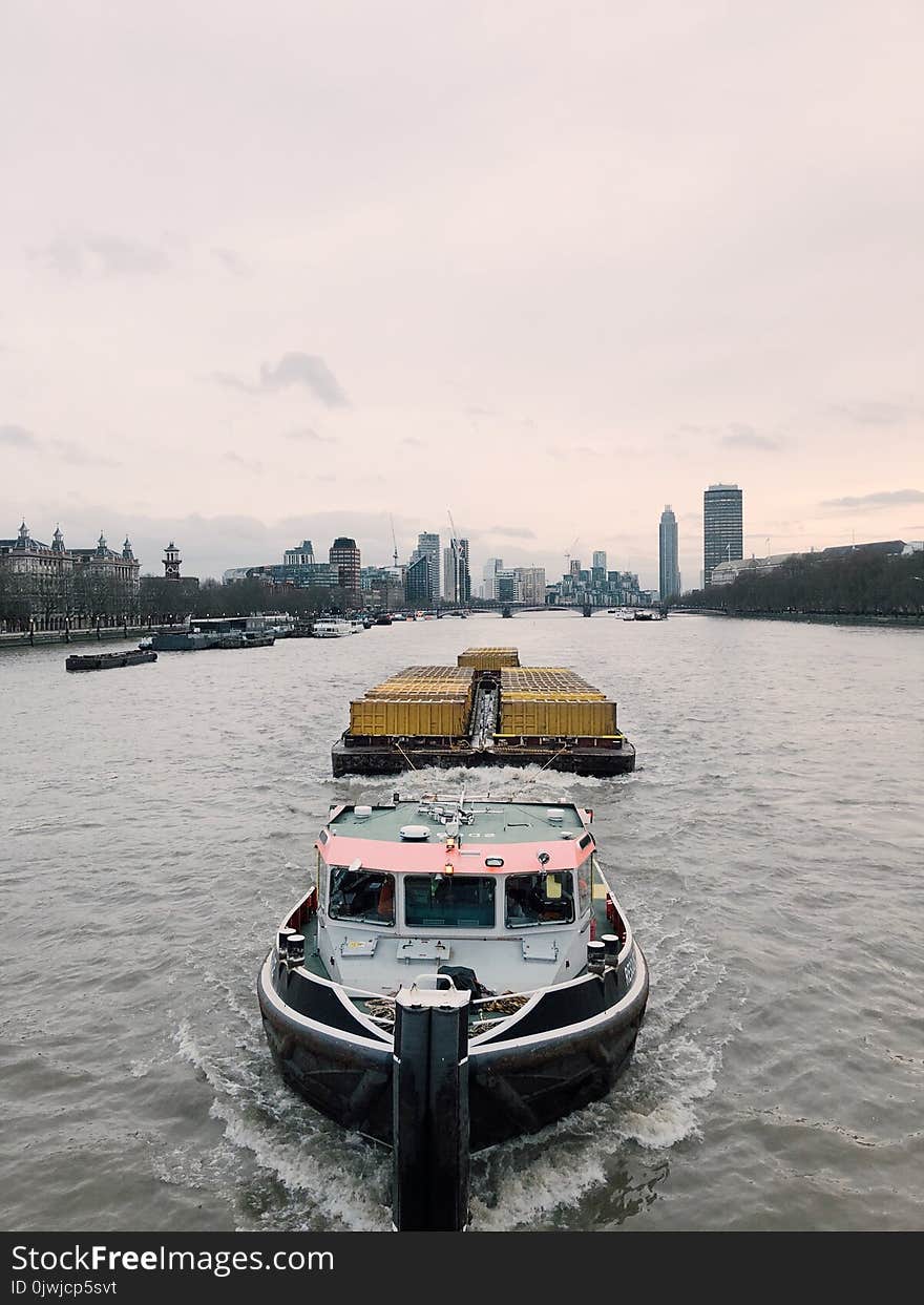 White and Black Boat on Body of Water